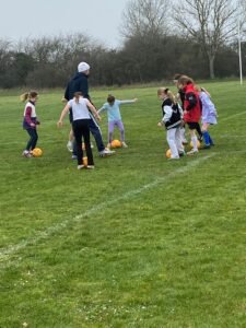 girls playing football with pass and move
